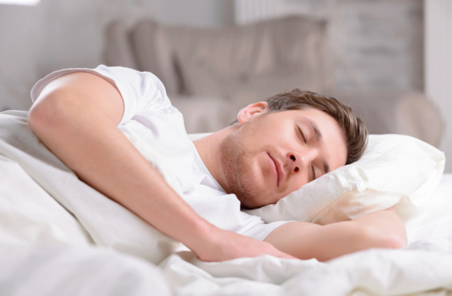 Man lying in bed sleeping 