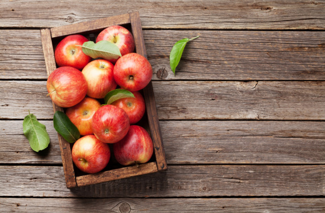 Ripe red apples in wooden box. Top view with space for your text