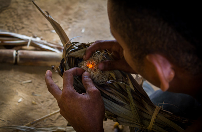 Ancient human starting a fire