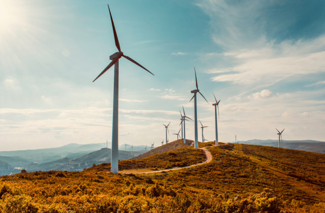 Wind turbines on beautiful sunny summer autumn mountain landscape.