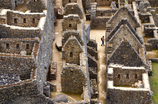 A man wanders through the ruins of Machu Picchu. (Credit: Russell Johnson/Shutterstock)