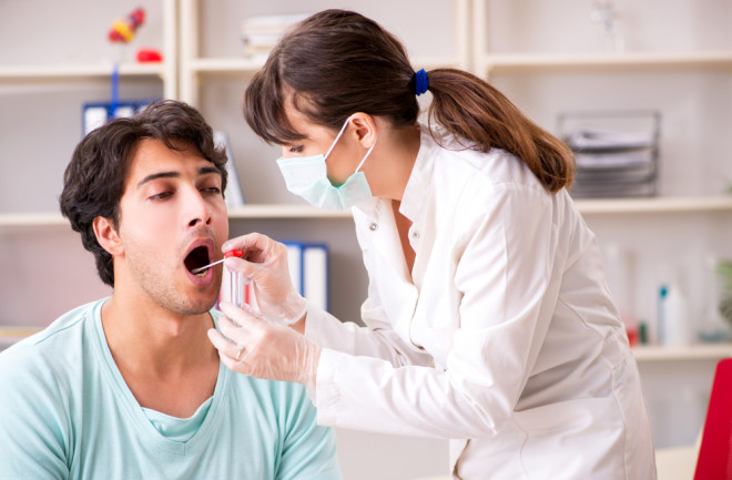 Doctor getting saliva test sample in clinic hospital