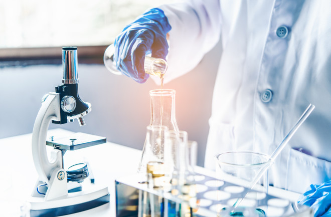 Equipment and science experiments oil pouring scientist with test tube yellow making research in laboratory.