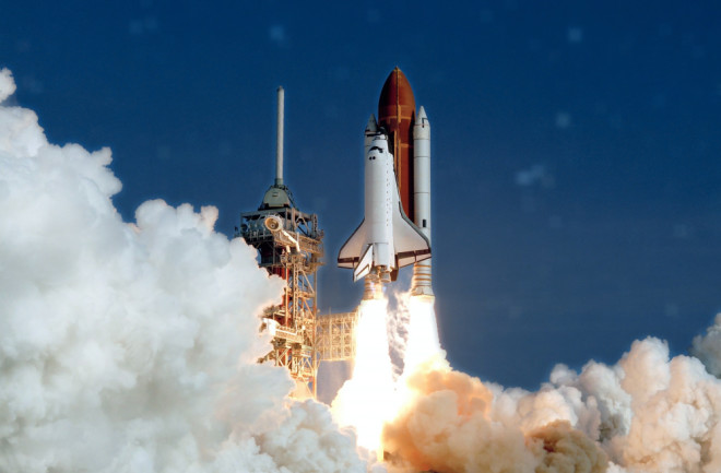 Take off space rocket on a background of blue sky and sun. Elements of this image were furnished by NASA