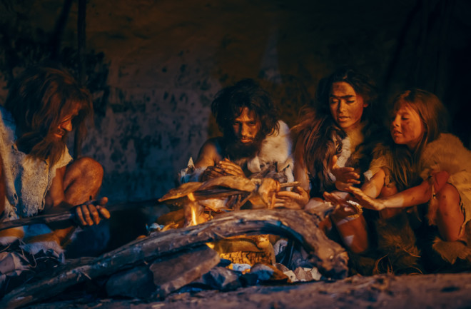 homo sapiens around a fire - shutterstock