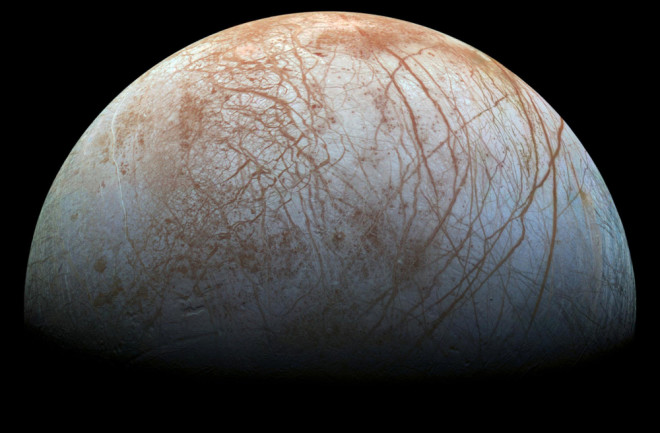 With an icy surface, Europa orbits Jupiter