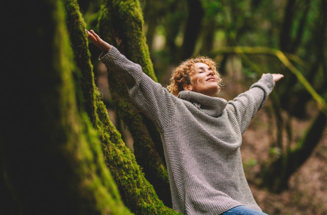 Overjoyed woman expresses contentment in nature 