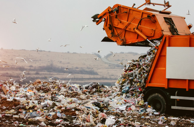 Garbage truck dumping the garbage on a landfill