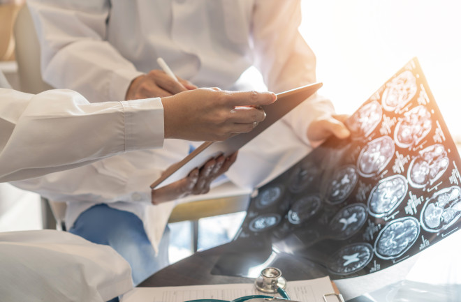 two-doctors-looking-at-a-brain-x-ray