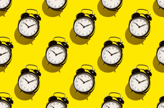 Alarm clocks on yellow background