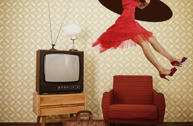 Woman wearing a red dress in a vintage living room traveling through time hole in celing